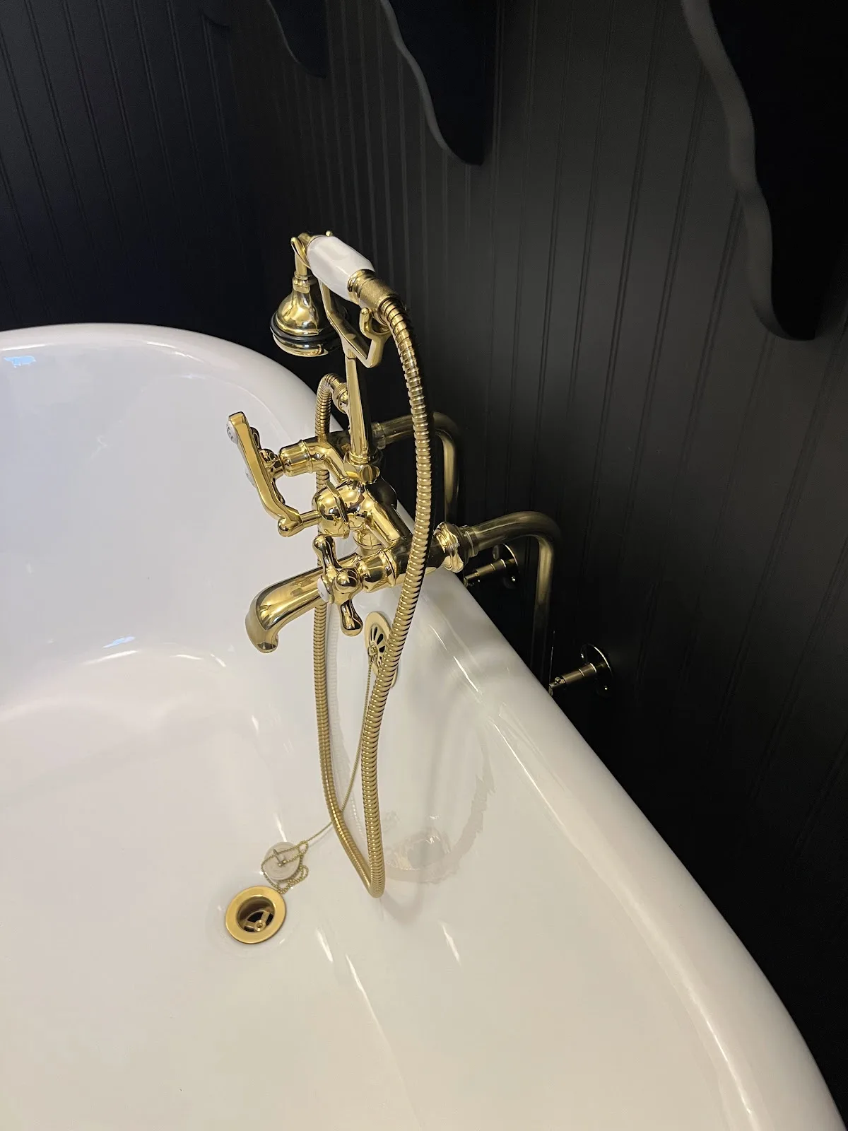 Bellingham church rectory bath with black walls, clawfoot tub and black-and-white mosaic tile floor in Bellingham, WA — Living By Design (3)