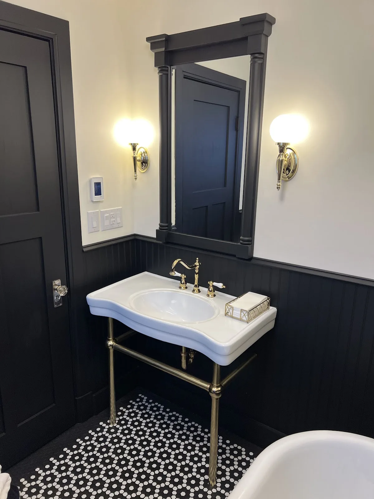 Bellingham church rectory bath with black walls, clawfoot tub and black-and-white mosaic tile floor in Bellingham, WA — Living By Design (4)