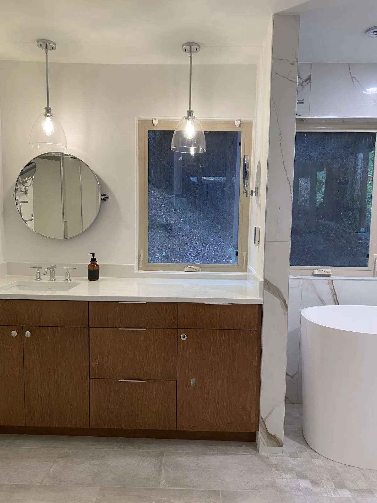 Bellingham bathroom with marble-look porcelain walls, wood vanity and freestanding tub in Bellingham, WA — Living By Design