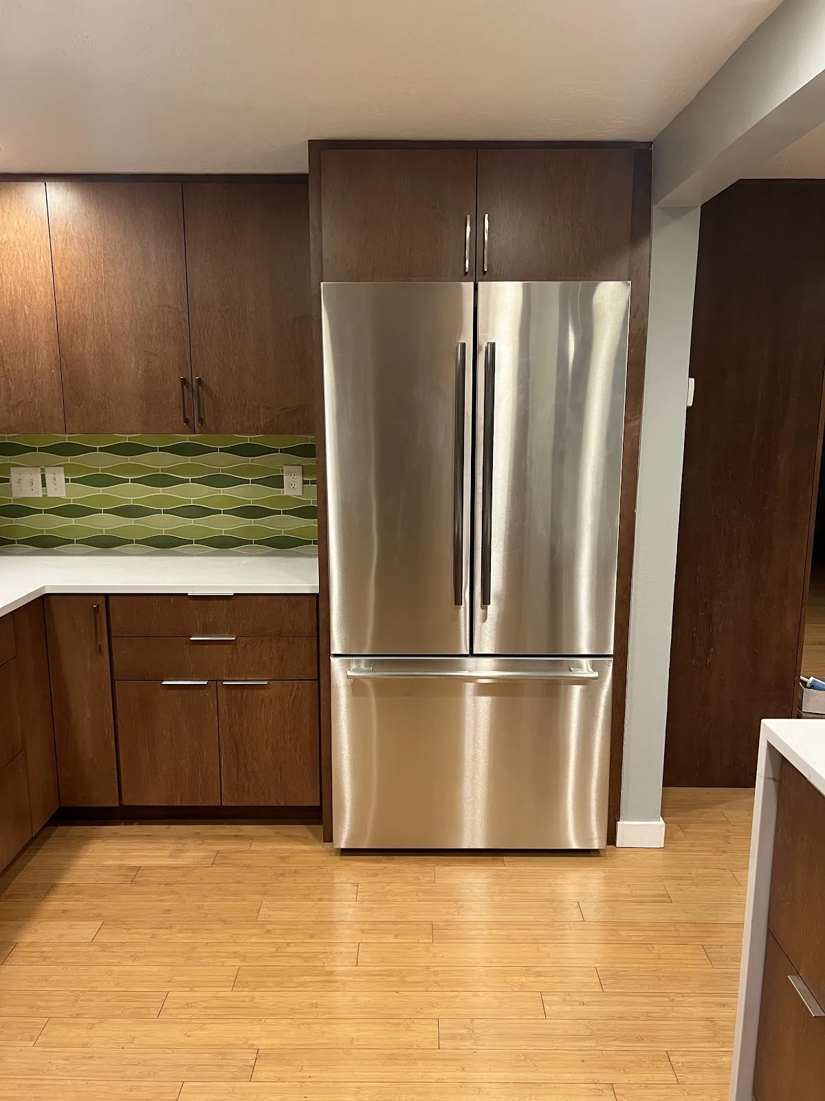 Mid-century Bellingham kitchen with wood cabinetry, quartz waterfall peninsula and green tile backsplash in Bellingham, WA — Living By Design (4)