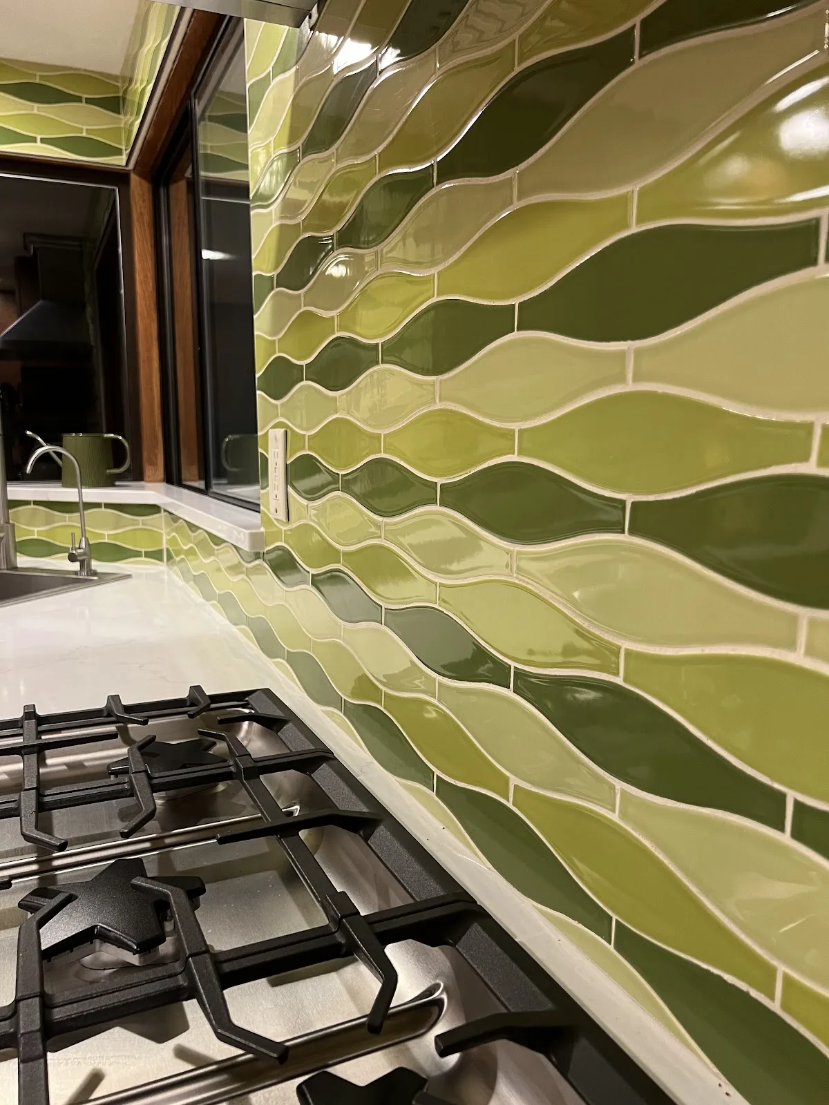 Mid-century Bellingham kitchen with wood cabinetry, quartz waterfall peninsula and green tile backsplash in Bellingham, WA — Living By Design (7)