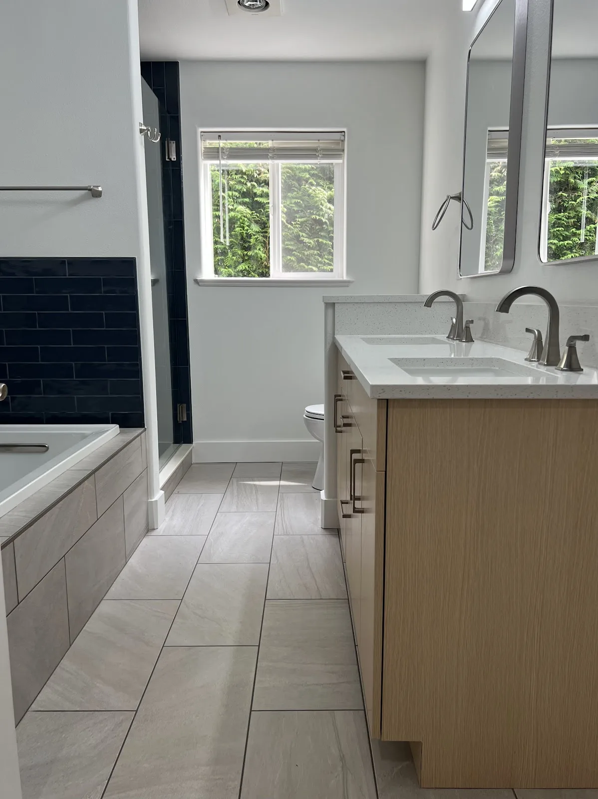 Bellingham bathroom with green and navy tile, wood vanity and freestanding tub in Bellingham, WA — Living By Design (2)