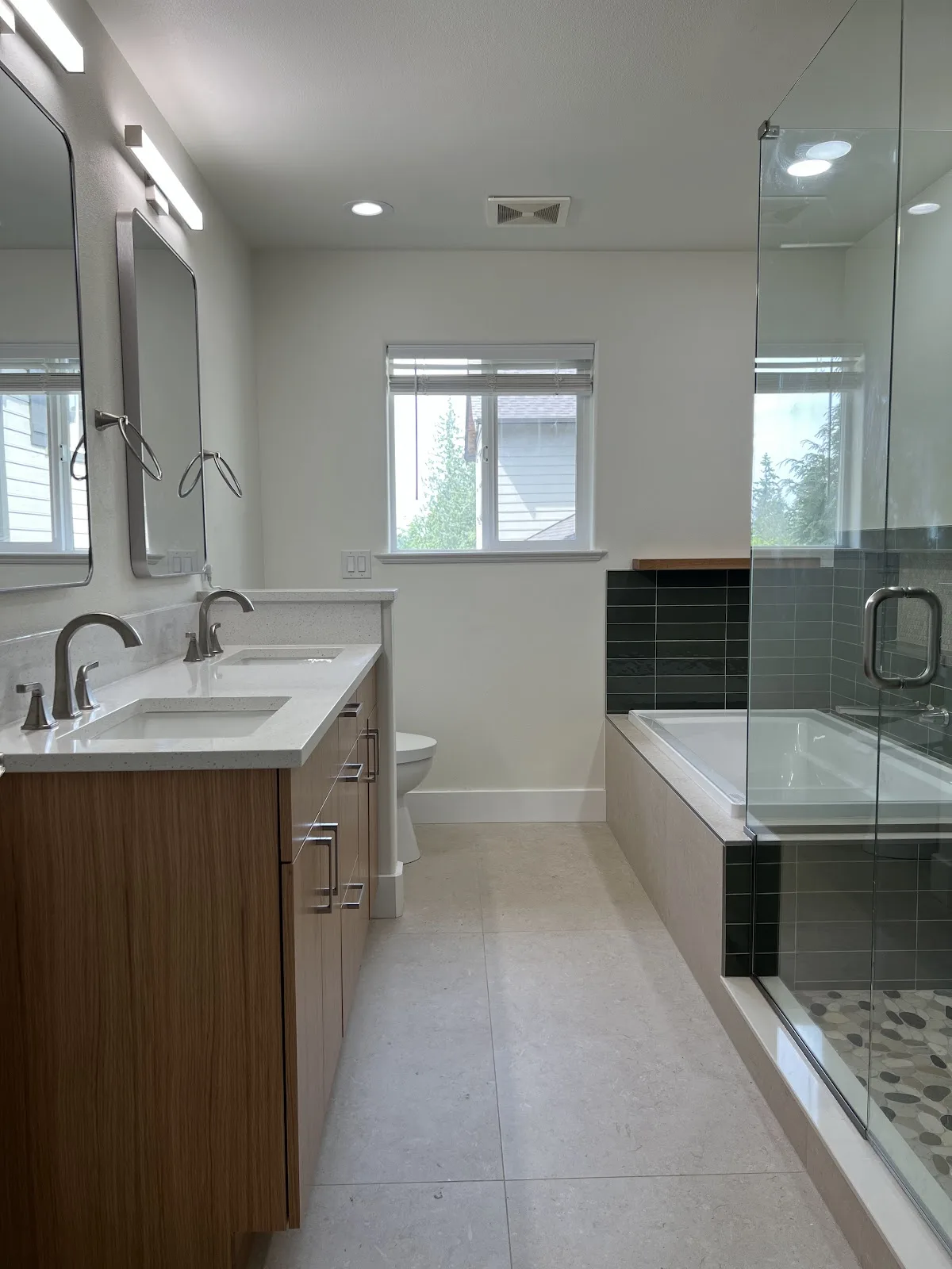 Bellingham bathroom with green and navy tile, wood vanity and freestanding tub in Bellingham, WA — Living By Design (5)