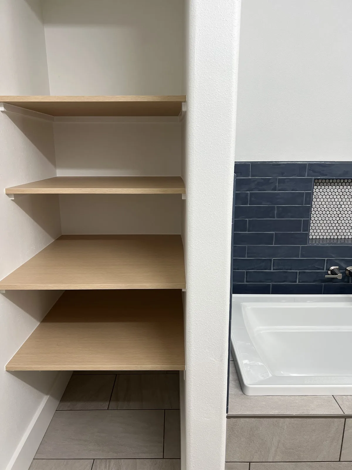 Bellingham bathroom with green and navy tile, wood vanity and freestanding tub in Bellingham, WA — Living By Design (8)