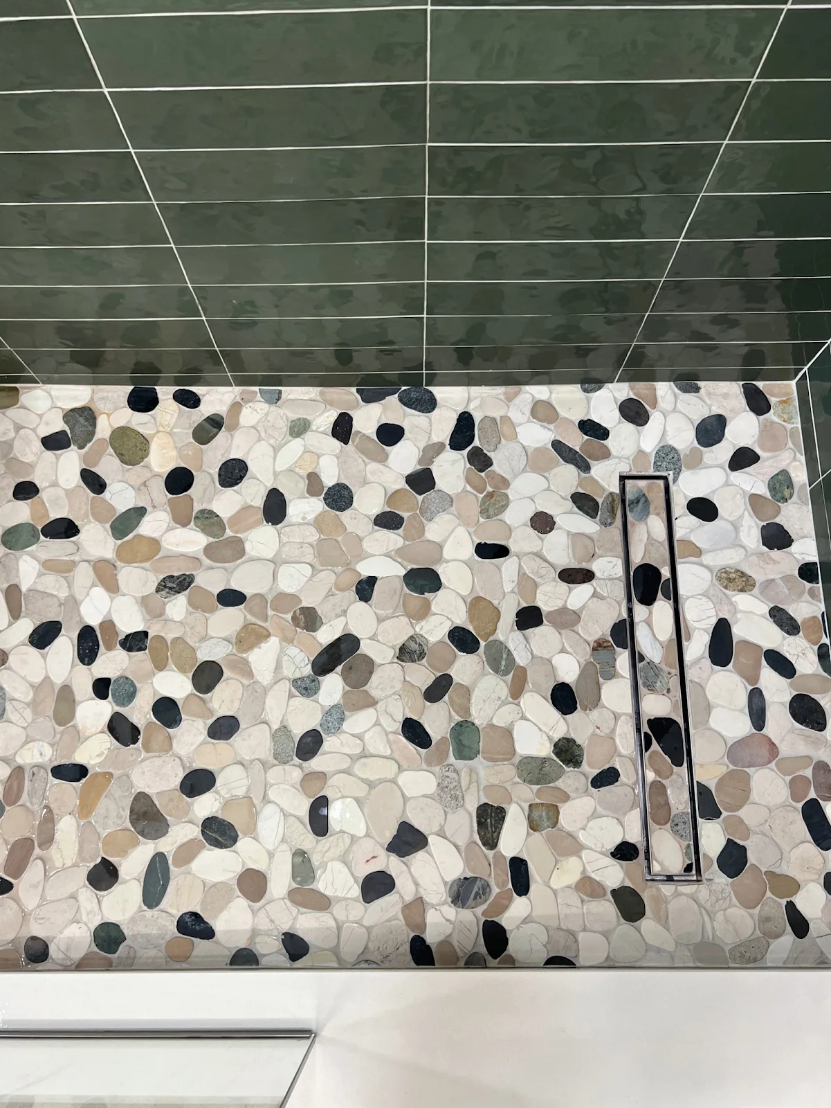 Bellingham bathroom with green and navy tile, wood vanity and freestanding tub in Bellingham, WA — Living By Design (11)