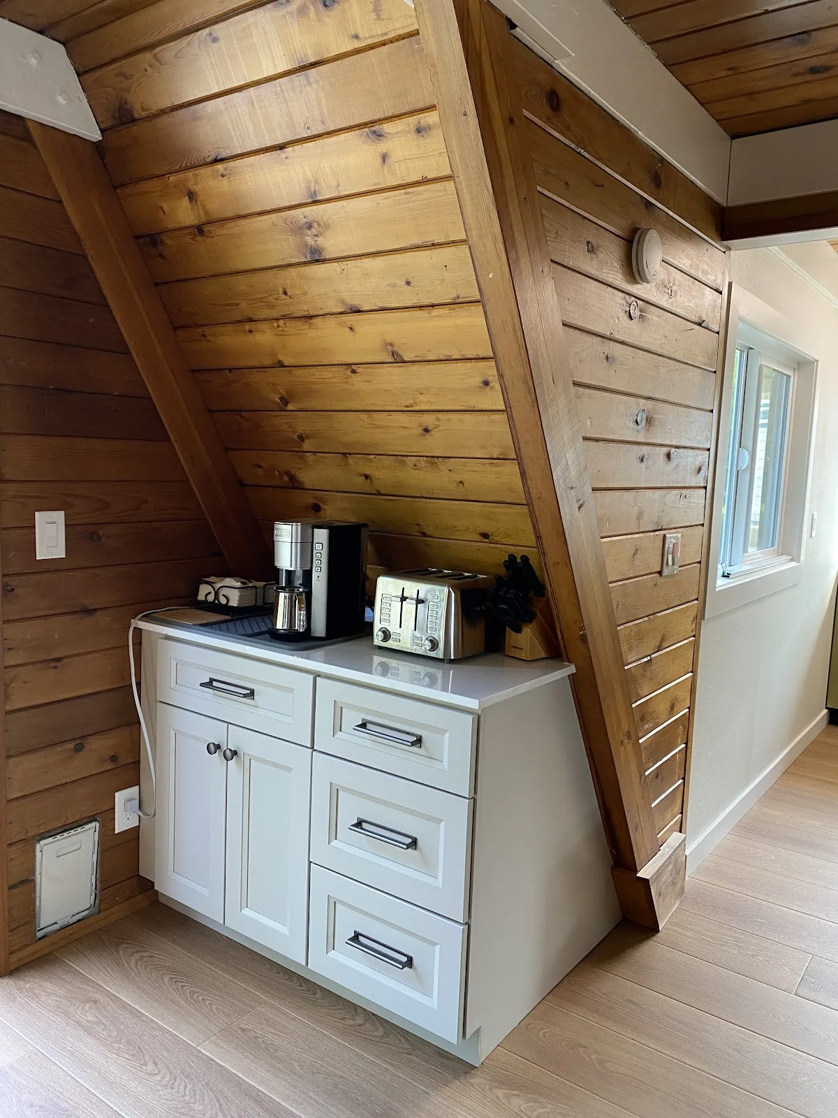 Blaine kitchen with white shaker cabinetry, quartz counters and wood-plank ceiling in Blaine, WA — Living By Design (5)