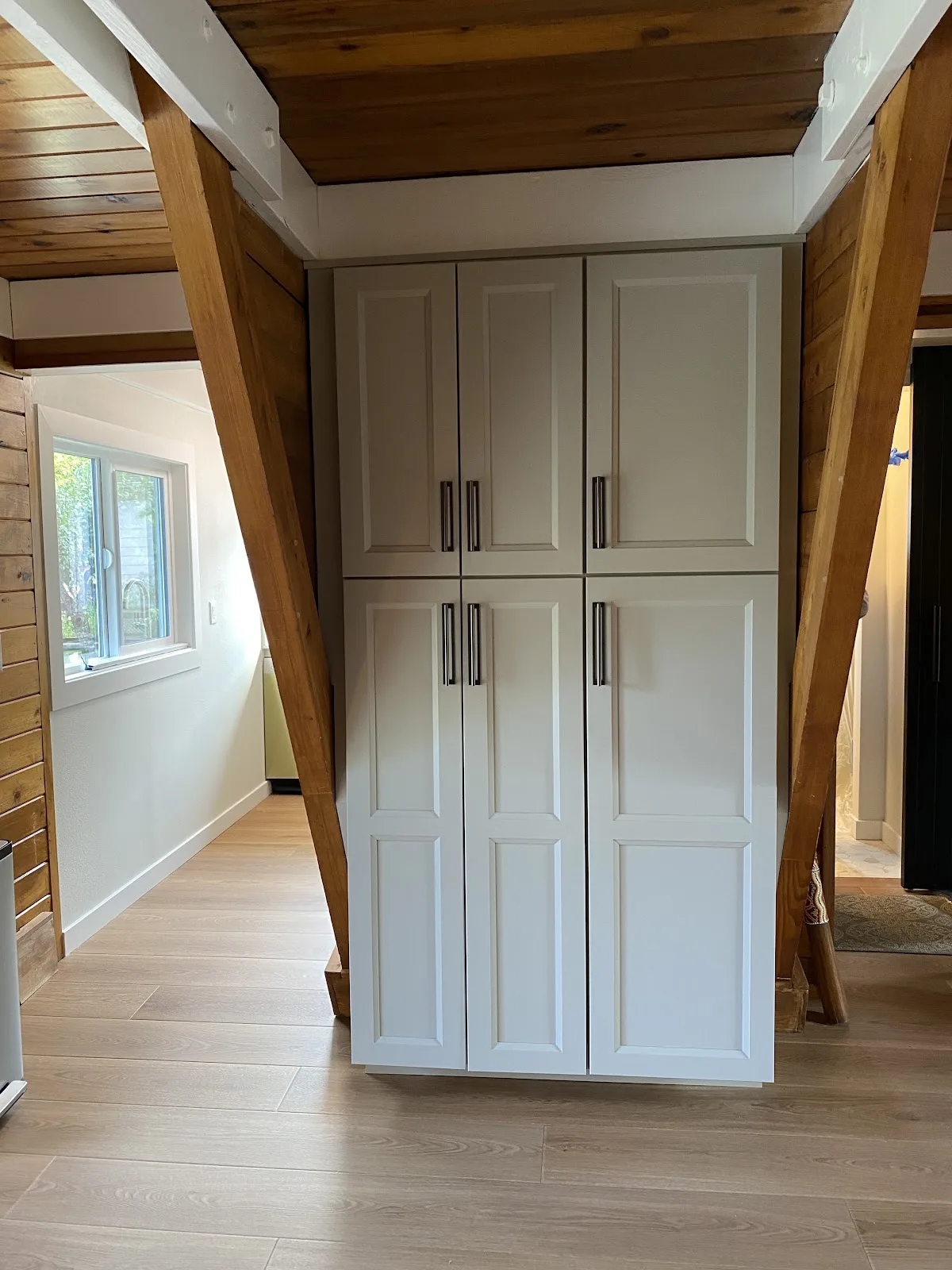 Blaine kitchen with white shaker cabinetry, quartz counters and wood-plank ceiling in Blaine, WA — Living By Design (6)