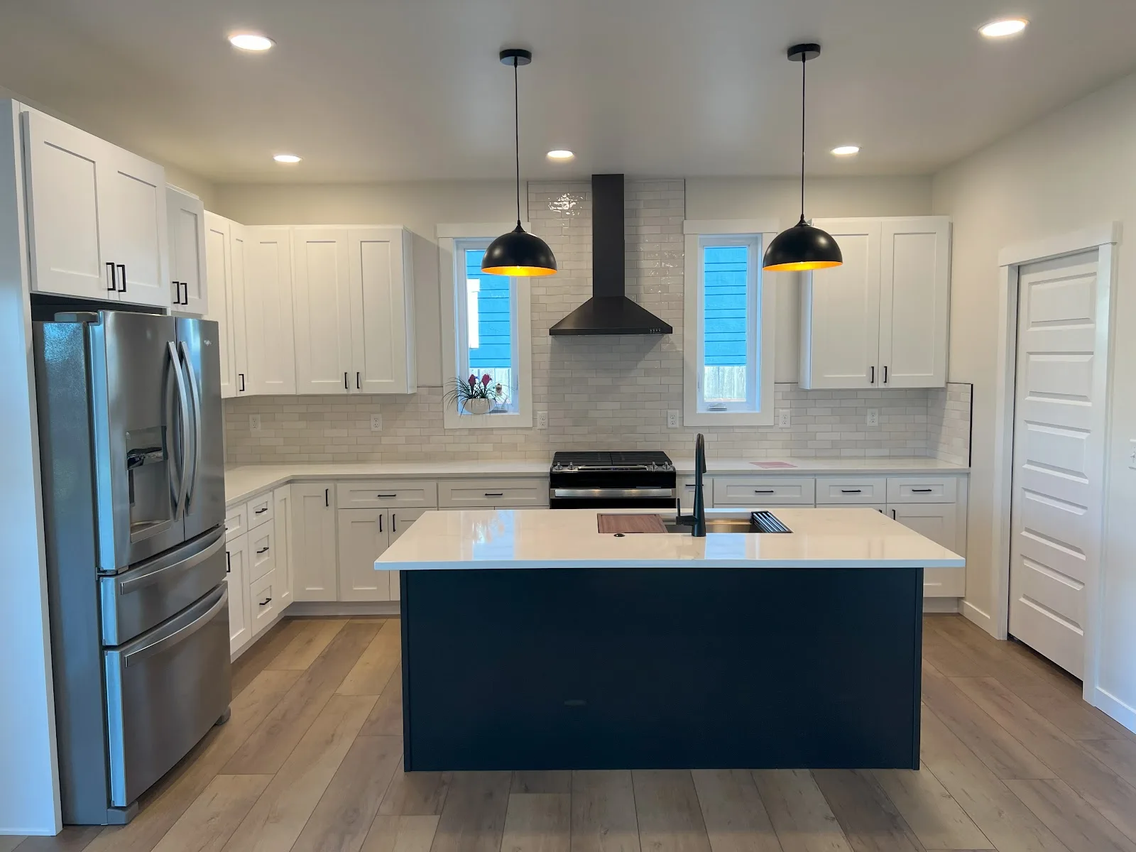 Everson new-build kitchen with navy island and quartz countertops in Everson, WA — Living By Design