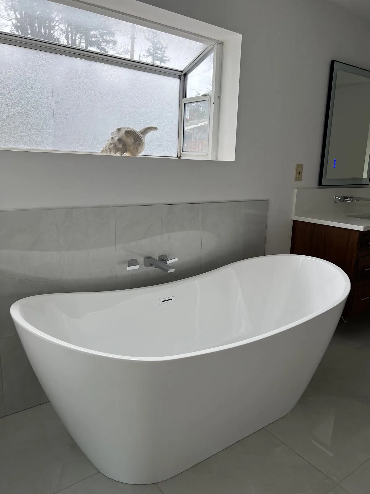 Ferndale bathroom with dark wood double vanity, quartz tops and freestanding slipper tub in Ferndale, WA — Living By Design