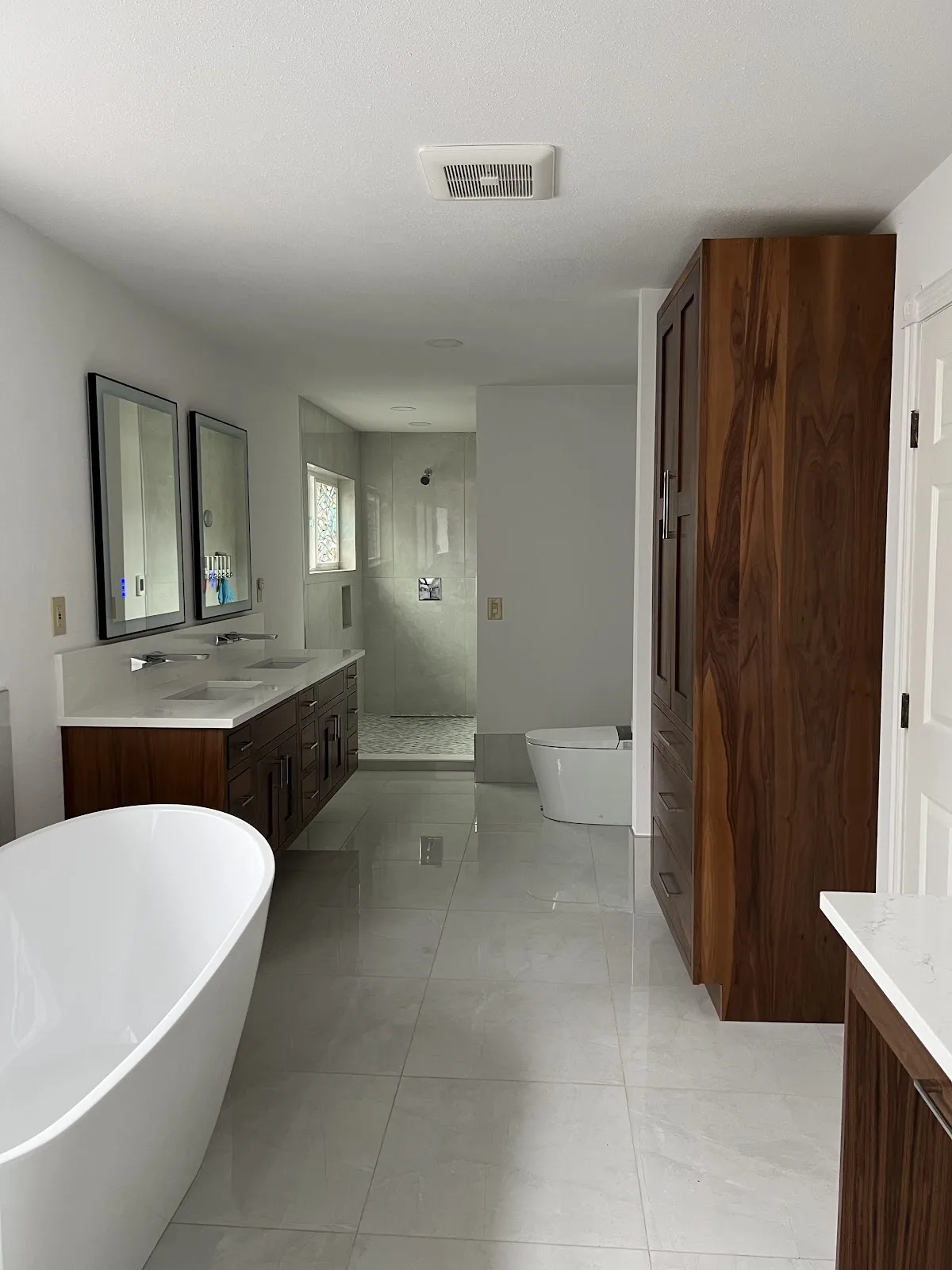 Ferndale bathroom with dark wood double vanity, quartz tops and freestanding slipper tub in Ferndale, WA — Living By Design (3)