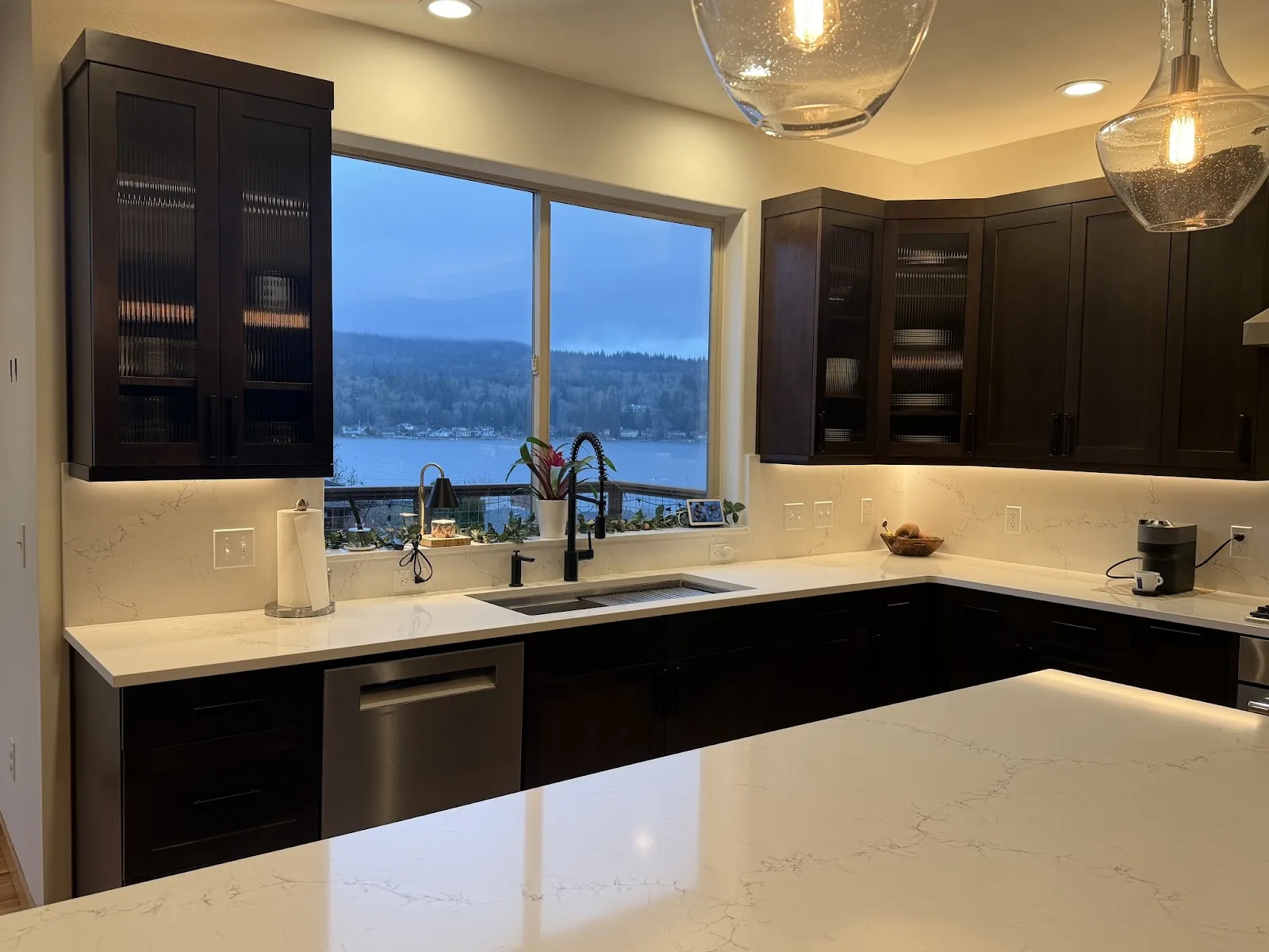 Cherry kitchen with quartz island and hardwood floors in Bellingham, WA — Living By Design (3)
