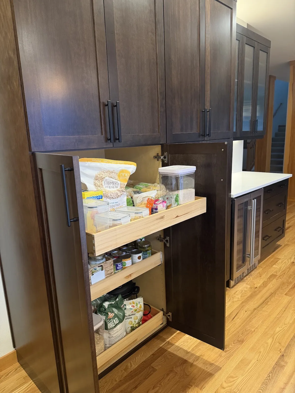 Cherry kitchen with quartz island and hardwood floors in Bellingham, WA — Living By Design (6)