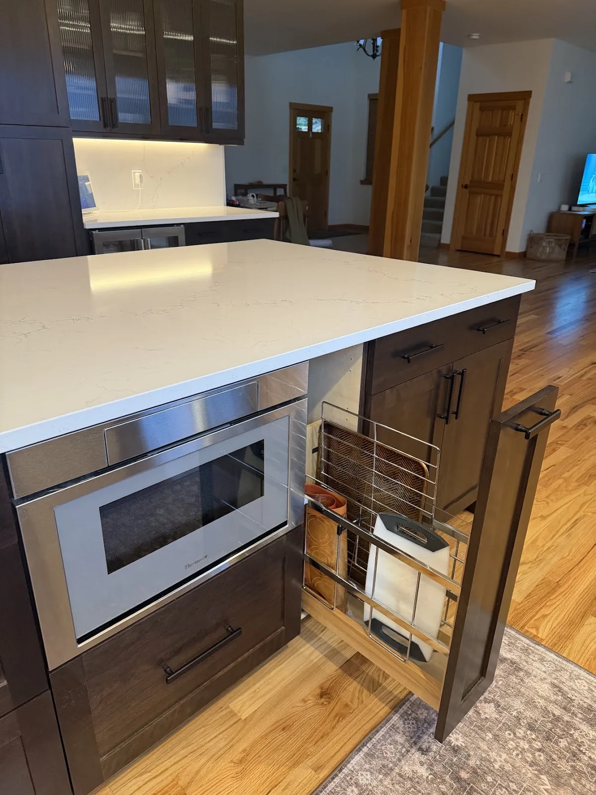 Cherry kitchen with quartz island and hardwood floors in Bellingham, WA — Living By Design (7)