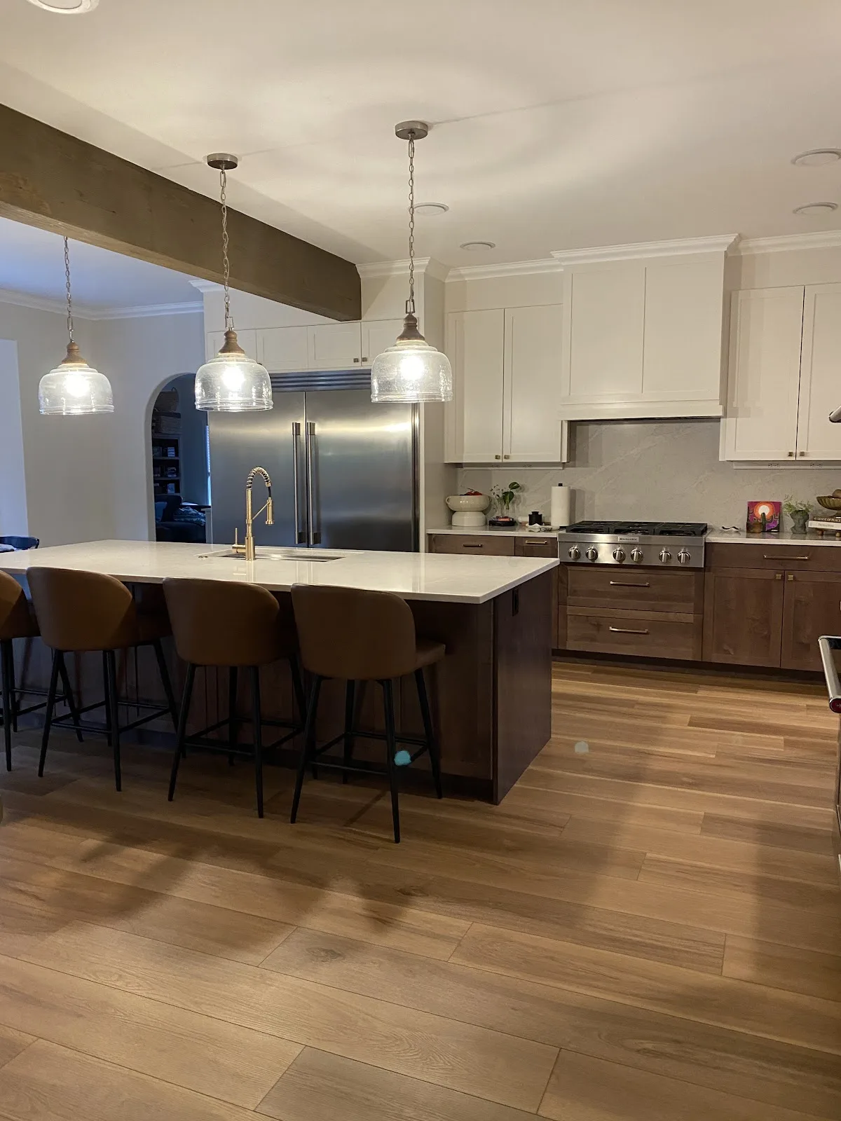 Bright white kitchen with quartz countertops and wood-look flooring in Bellingham, WA — Living By Design