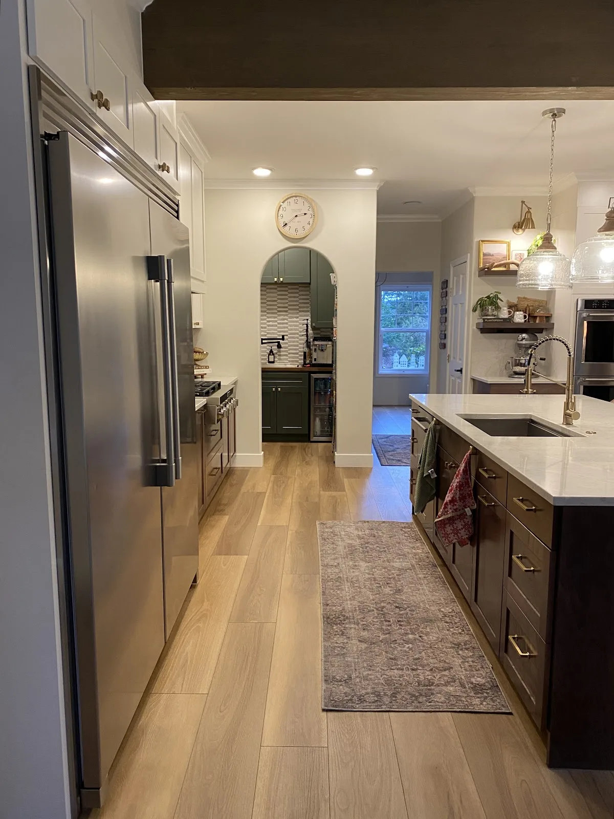 Bright white kitchen with quartz countertops and wood-look flooring in Bellingham, WA — Living By Design (3)