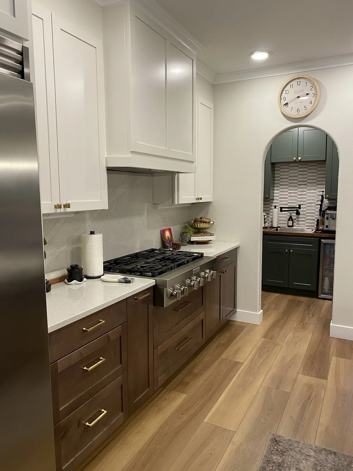 Bright white kitchen with quartz countertops and wood-look flooring in Bellingham, WA — Living By Design (4)