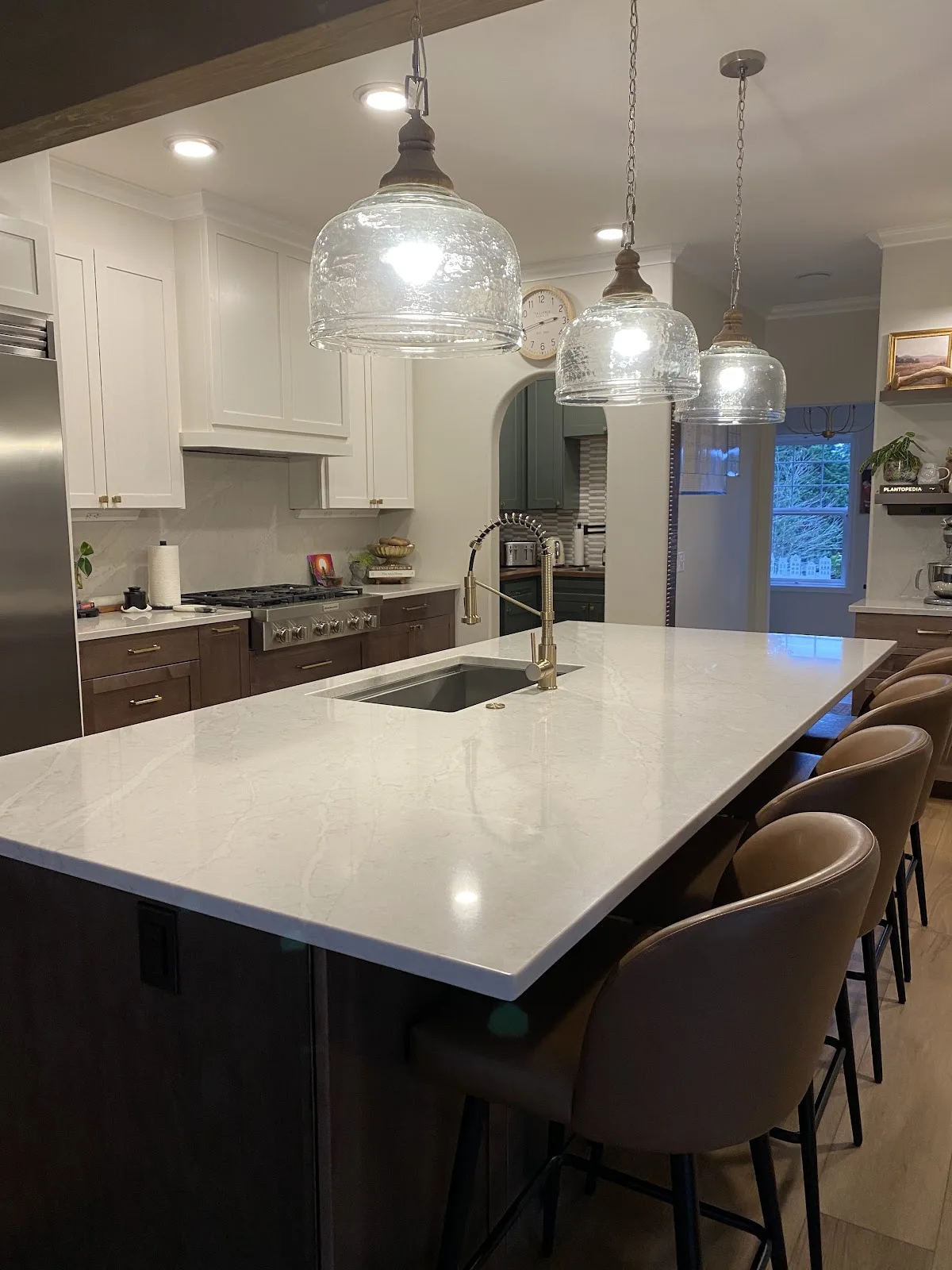 Bright white kitchen with quartz countertops and wood-look flooring in Bellingham, WA — Living By Design (5)