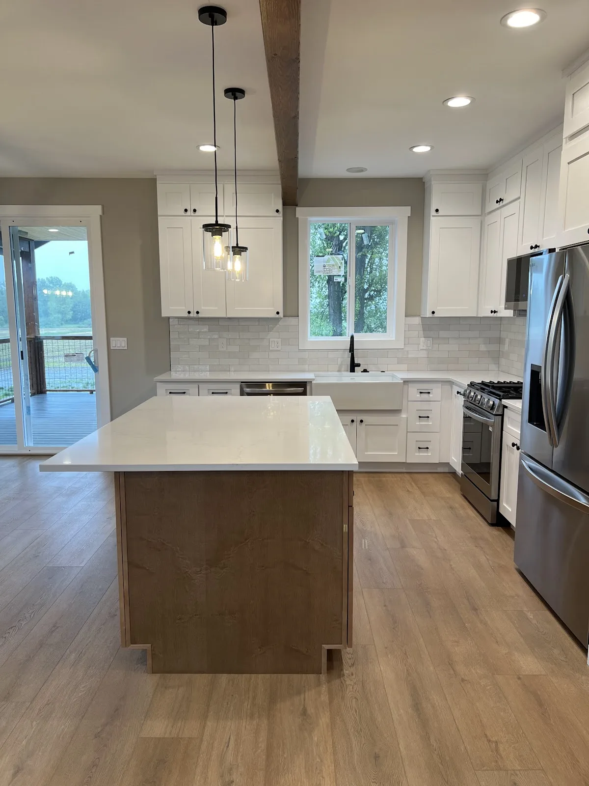 Lynden new-build kitchen with white shaker cabinetry and wood island in Lynden, WA — Living By Design