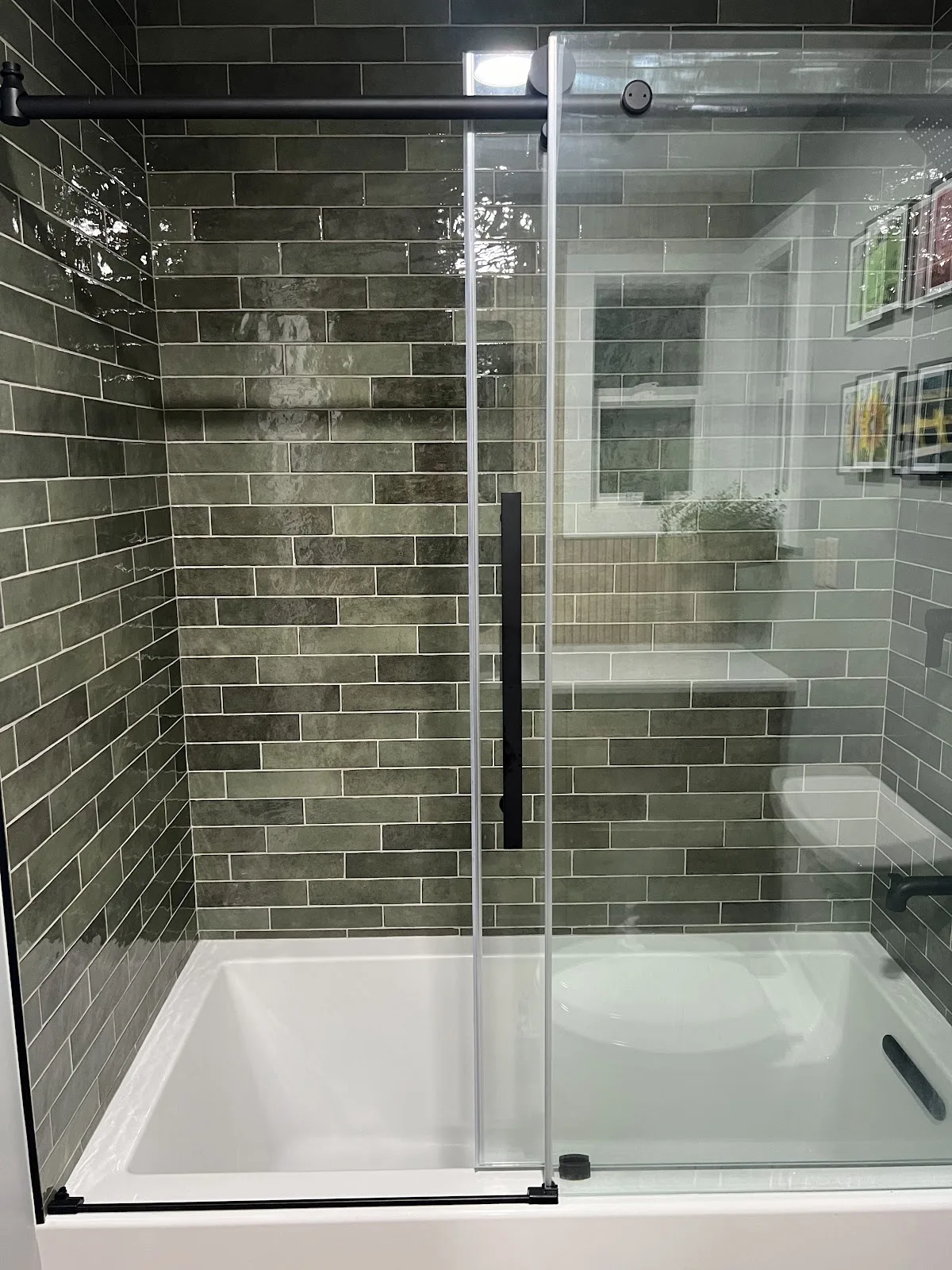 Bathroom with wood vanity and a tiled walk-in glass shower in Bellingham, WA — Living By Design (3)