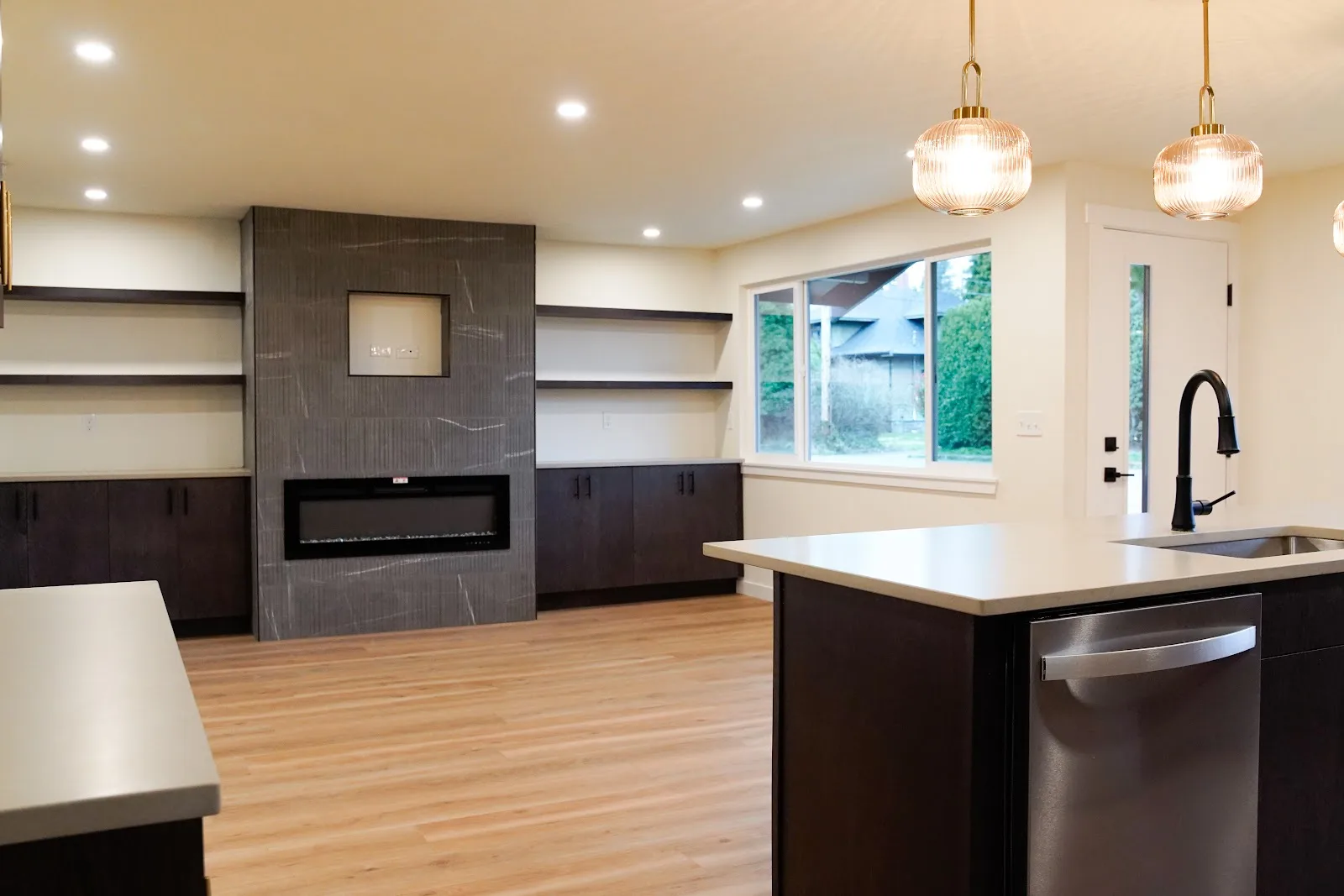 Kitchen and bath remodel with stained cabinetry, quartz island and a tiled fireplace wall in Bellingham, WA — Living By Design (2)