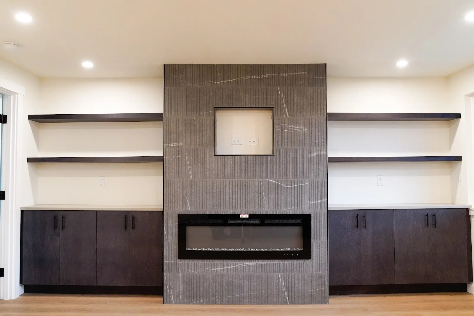 Kitchen and bath remodel with stained cabinetry, quartz island and a tiled fireplace wall in Bellingham, WA — Living By Design (4)