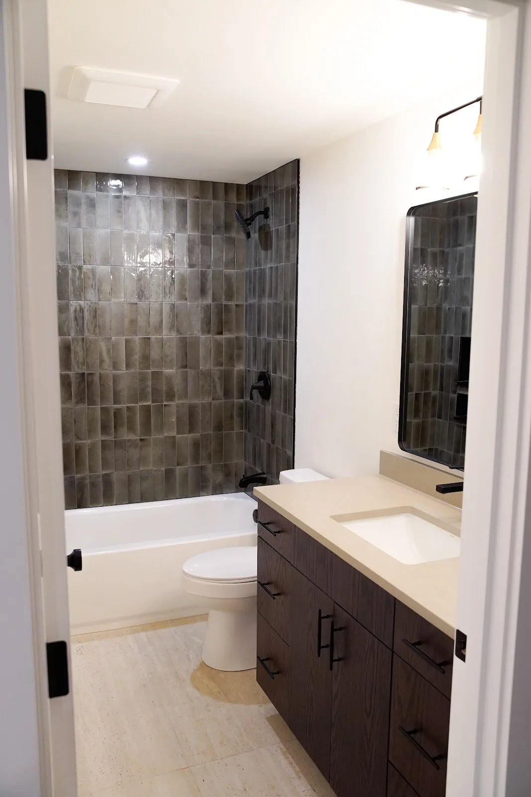 Kitchen and bath remodel with stained cabinetry, quartz island and a tiled fireplace wall in Bellingham, WA — Living By Design (7)