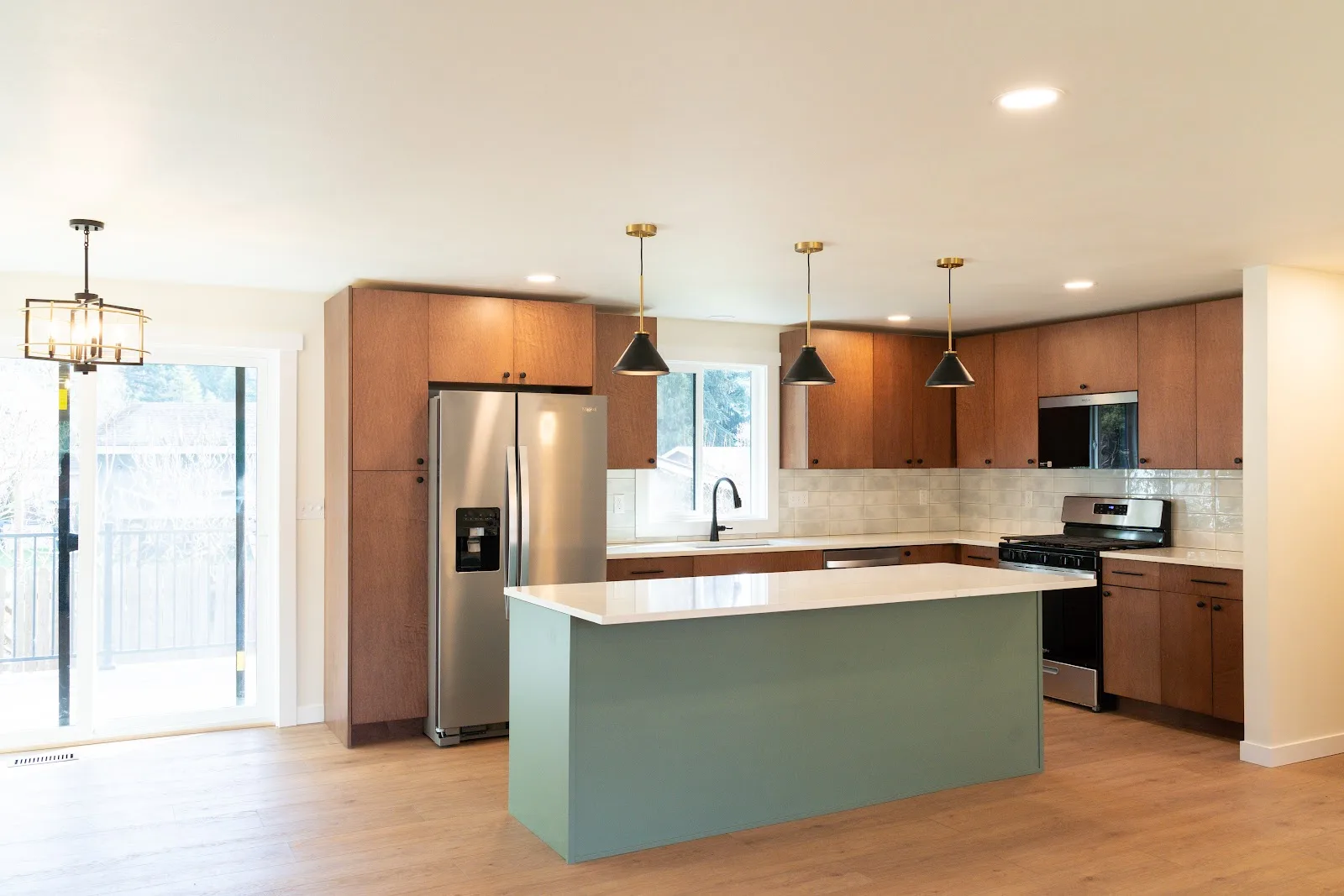 Kitchen with wood cabinets and a painted island, plus a tiled bath, in Ferndale, WA — Living By Design