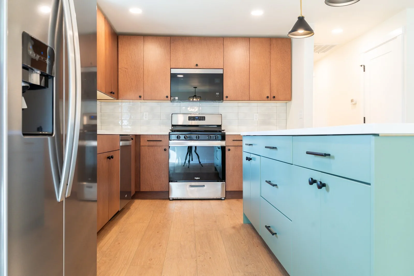 Kitchen with wood cabinets and a painted island, plus a tiled bath, in Ferndale, WA — Living By Design (2)