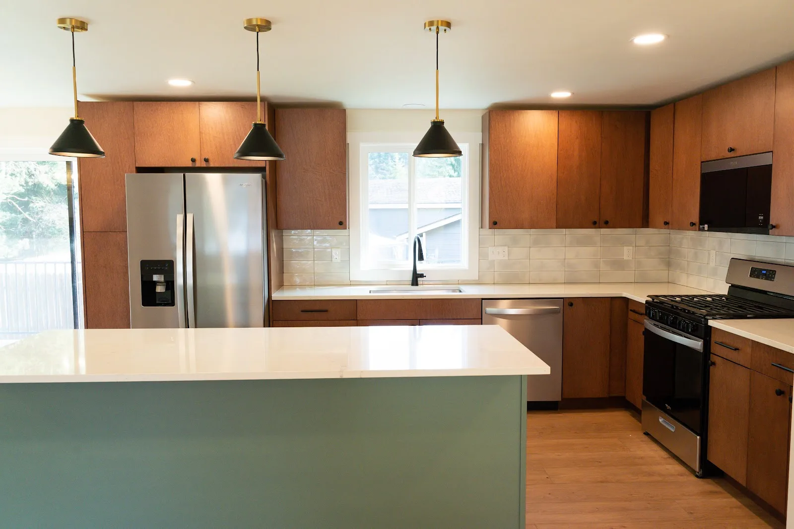 Kitchen with wood cabinets and a painted island, plus a tiled bath, in Ferndale, WA — Living By Design (3)