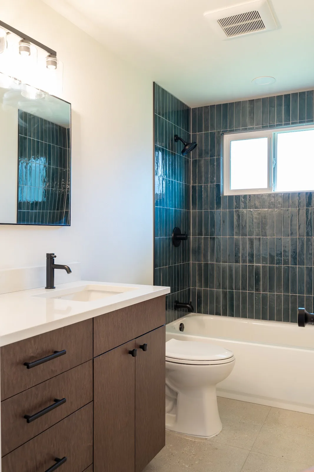 Kitchen with wood cabinets and a painted island, plus a tiled bath, in Ferndale, WA — Living By Design (5)