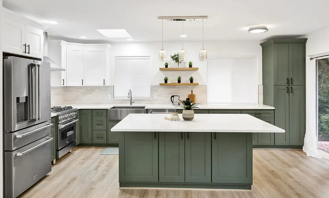 Sudden Valley kitchen with sage-green cabinetry and quartz island in Bellingham, WA — Living By Design