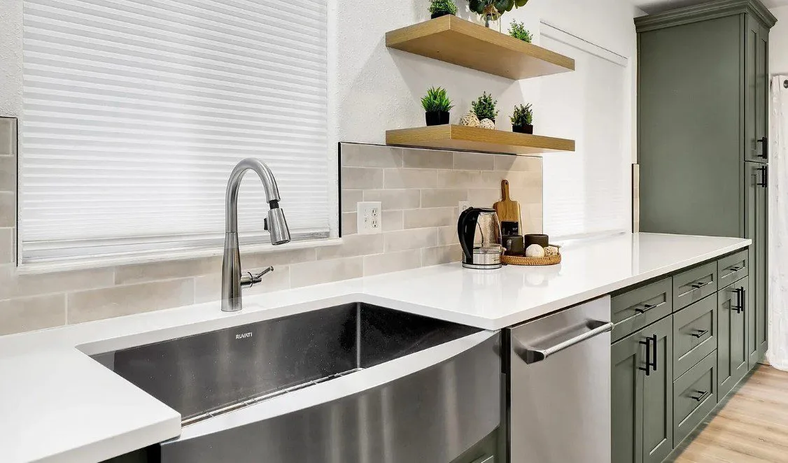Sudden Valley kitchen with sage-green cabinetry and quartz island in Bellingham, WA — Living By Design (4)