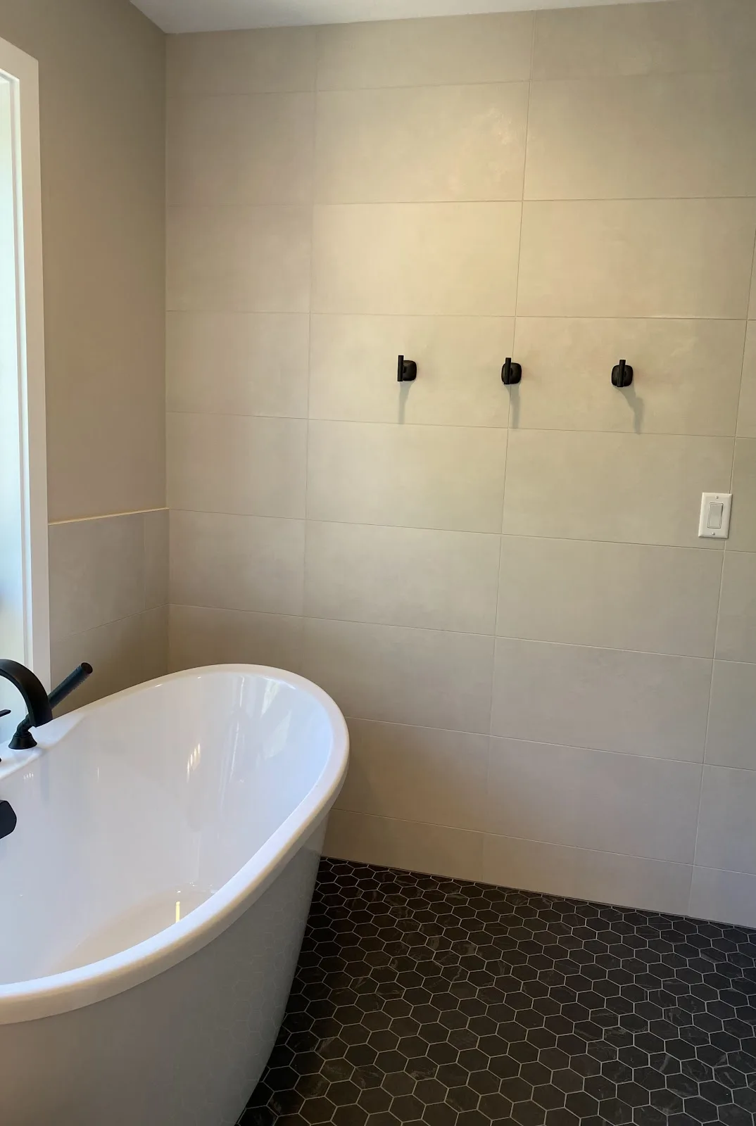 New-construction home in Bellingham with tile floors and tub-shower tile — Living By Design